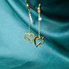 gold plated earrings with freshwater pearls and hanging hearts, hearts charms earrings, charms in heart shape, long earrings, handmade gold designs, handmade gold creations.