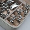 KIRKI Embrace Silver Steel Ring in stainless steel with silver plated finish. A contemporary jewelry piece with elegant curves that gracefully hug your fingers.