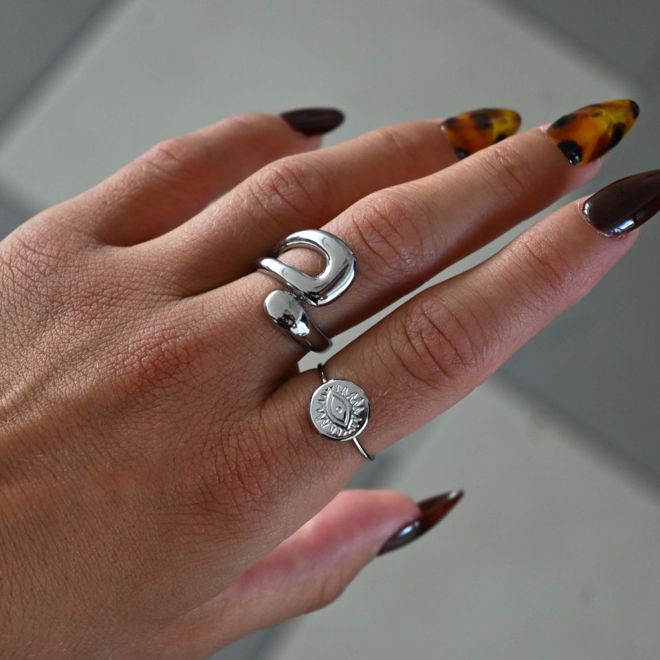 KIRKI Embrace Silver Steel Ring in stainless steel with silver plated finish. A contemporary jewelry piece with elegant curves that gracefully hug your fingers.