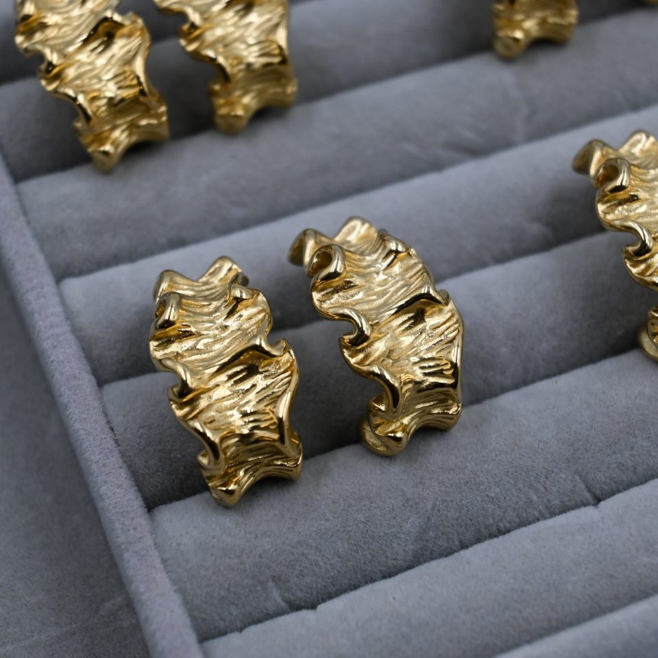 crinkle gold hoop earring in jewelry display