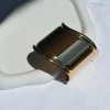 Bold and unforgettable, the Hera Gold Statement Bangle channels ancient Greek beauty with mirror shine. A statement hinged handcuff in 18K gold-plated stainless steel with a glossy, reflective finish.