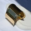 Bold and unforgettable, the Hera Gold Statement Bangle channels ancient Greek beauty with mirror shine. A statement hinged handcuff in 18K gold-plated stainless steel with a glossy, reflective finish.