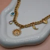 Soleil Gold Steel Charm Necklace with 18K gold-plated steel chain and hanging charms including steel heart, moon, peephole and a zircon. Water-resistant must-have summer jewelry for women.