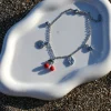 Experience the most viral moment of the summer with the Cherries Silver Steel Charm Anklet. Crafted from stainless steel with a shiny silver finish, it features an elongated steel chain and hanging steel charms with cherries, sun, leaf, star and heart.