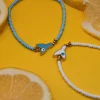 Summer steel mermaid tail anklet with evil eye turquoise. Featuring a gold plated steel chain that fluctuates, turquoise glass grommets and a central steel charm with mermaid tail. Water-resistant summer jewelry for every woman.