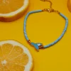 Summer steel mermaid tail anklet with evil eye turquoise. Featuring a gold plated steel chain that fluctuates, turquoise glass grommets and a central steel charm with mermaid tail. Water-resistant summer jewelry for every woman.
