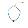 Summer steel mermaid tail pearl anklet with turquoise howlite stones. Featuring a gold plated steel chain that fluctuates, freshwater pearls and a central gold steel charm with mermaid tail. Water-resistant summer jewelry for every woman.
