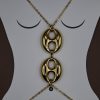 The Seraphine Harness Body Chain in stainless steel with gold plating, features bold interlocking links — the ultimate statement piece of strength and sensuality.