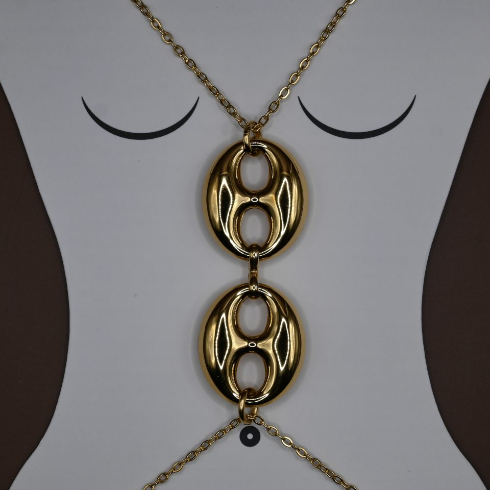 The Seraphine Harness Body Chain in stainless steel with gold plating, features bold interlocking links — the ultimate statement piece of strength and sensuality.