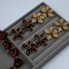 Daisy Enamel Earrings in beige or burgundy — 18-karat gold-plated stainless steel flower studs with enamel petals, elegant hypoallergenic earrings for women.