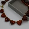 Heart Tartaruga Resin Necklace featuring chunky heart-shaped resin stones in tortoiseshell tones and a gold-plated steel chain — a bold, trendy statement necklace for women.