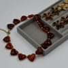 Heart Tartaruga Resin Necklace featuring chunky heart-shaped resin stones in tortoiseshell tones and a gold-plated steel chain — a bold, trendy statement necklace for women.