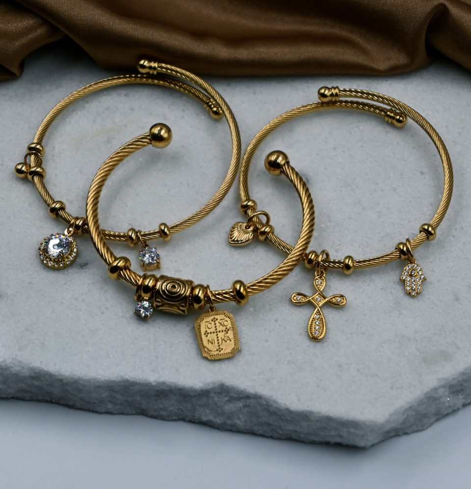 Gold plated stainless steel bracelet with Constantinato charm, evil eye charm, and sparkling zircon charm