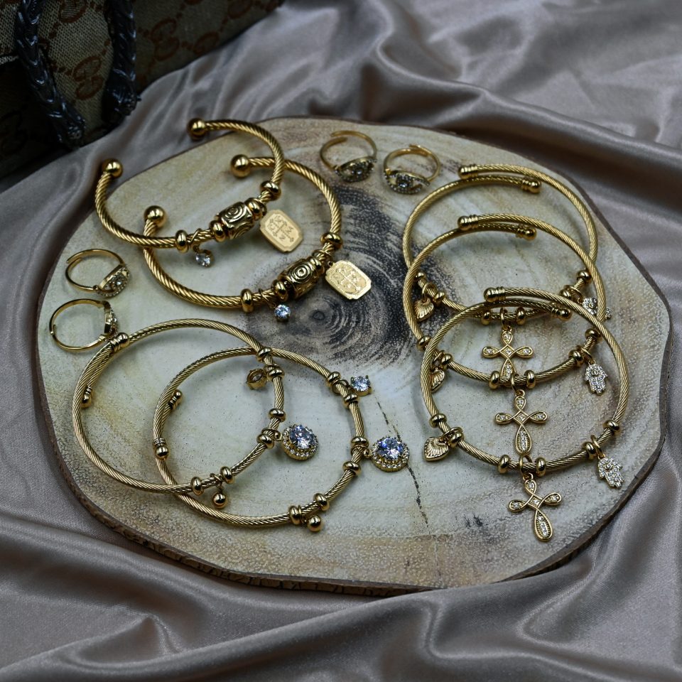 Gold plated stainless steel bracelet with Constantinato charm, evil eye charm, and sparkling zircon charm