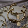 Gold plated stainless steel bracelet with Constantinato charm, evil eye charm, and sparkling zircon charm