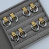 The Eterna Duo Glossy Earrings are a must-have silver and gold jewelry piece, going viral on TikTok and Instagram. Made from durable stainless steel, these earrings add a modern touch to any outfit