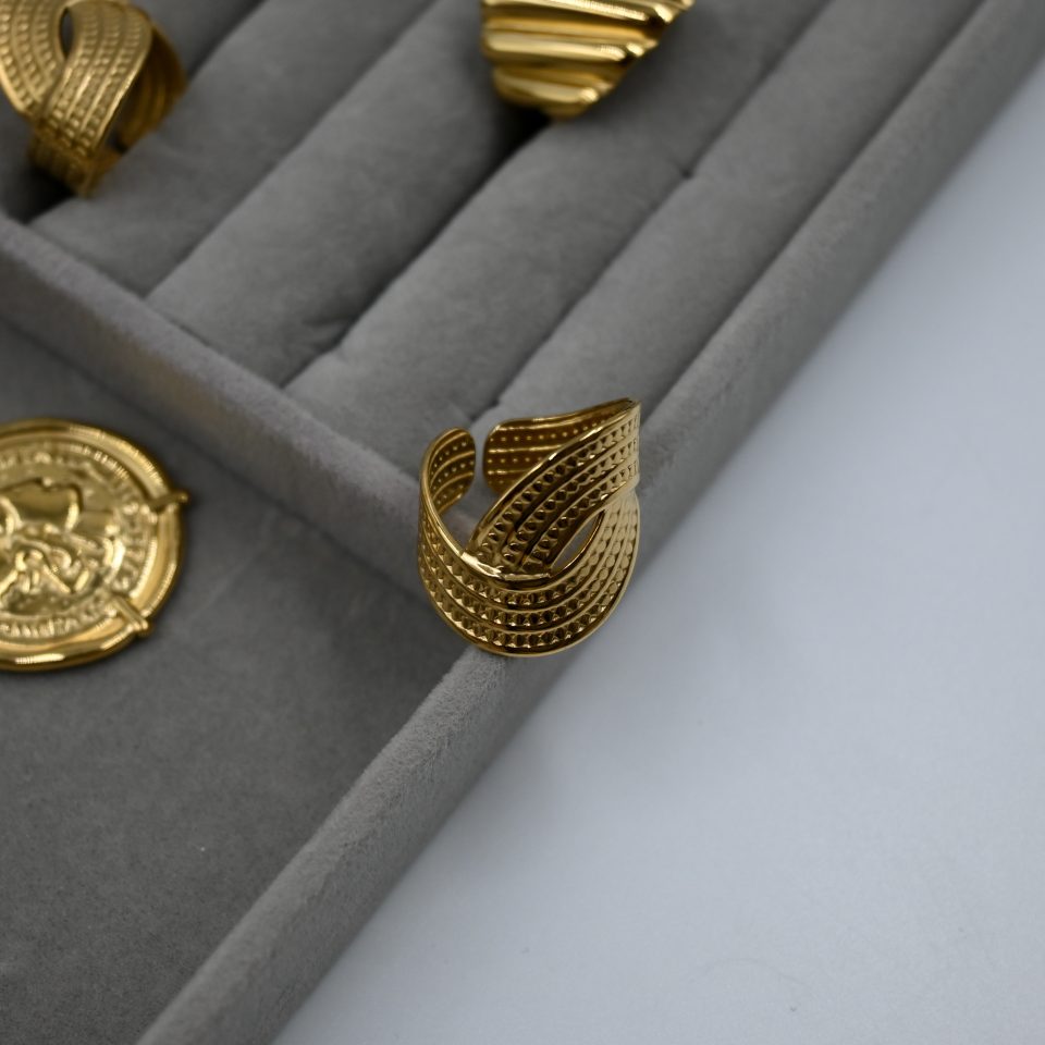 Gold-plated adjustable ring with vintage sculptural embossed design.