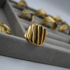 Radiant and sculptural, the Lume Vintage Gold Ring features a polished gold-plated embossed design with an adjustable band. A luxurious timeless design for women.