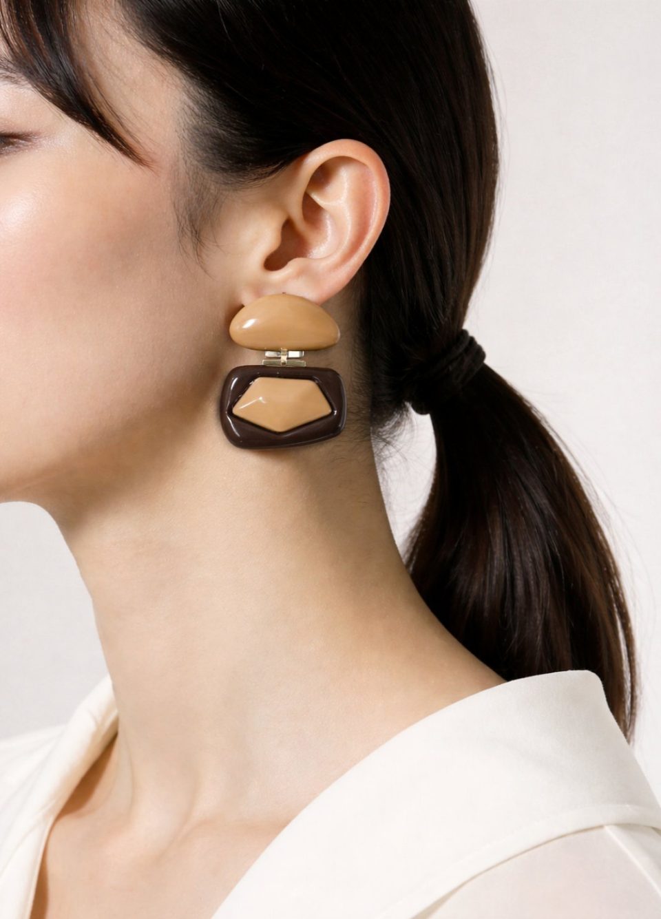 Handmade resin earrings with sculptural geometric design in brown and beige tones and gold-plated steel details. Handmade boho chic earrings for women.