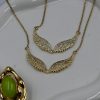 Viral Angel Wings Zircon Necklace in 18K gold-plated stainless steel. Sparkling zircon and angel-wing charm for layered or statement jewelry looks.