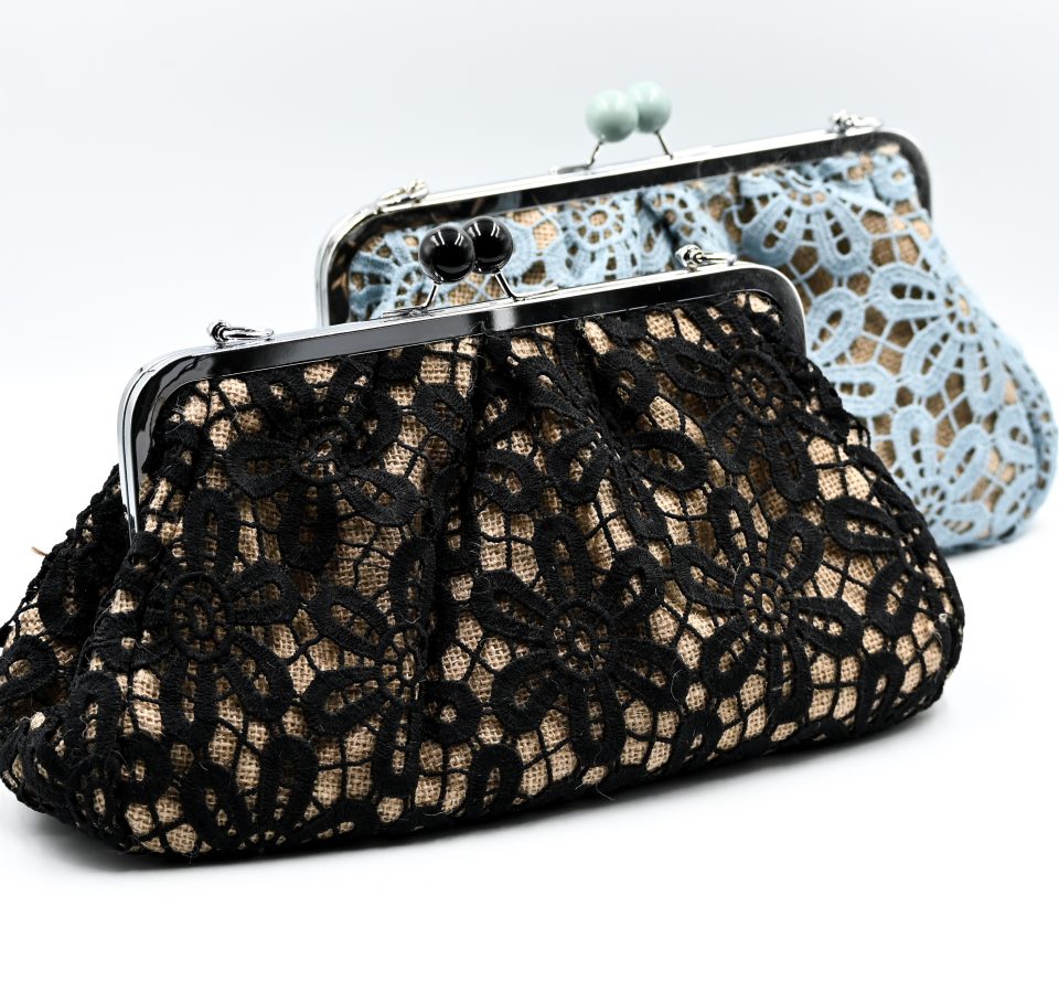 Handmade raffia clutch bag with a black lace exterior lining and a detachable silver metal chain. This raffia clutch bag combines vintage charm with modern versatility. Perfect for everyday elegance or formal occasions, such as a christening or a wedding.