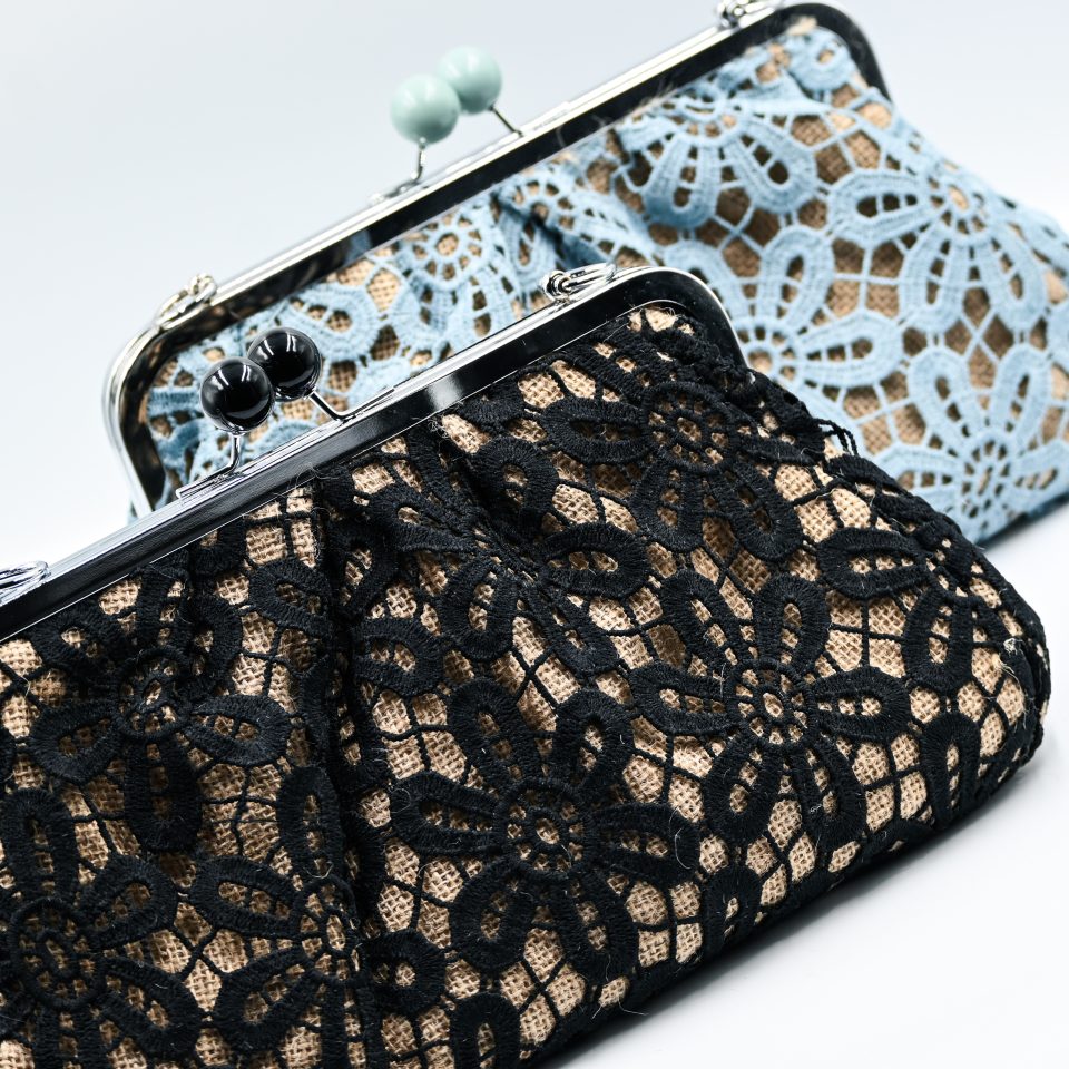 Handmade raffia clutch bag with a black lace exterior lining and a detachable silver metal chain. This raffia clutch bag combines vintage charm with modern versatility. Perfect for everyday elegance or formal occasions, such as a christening or a wedding.