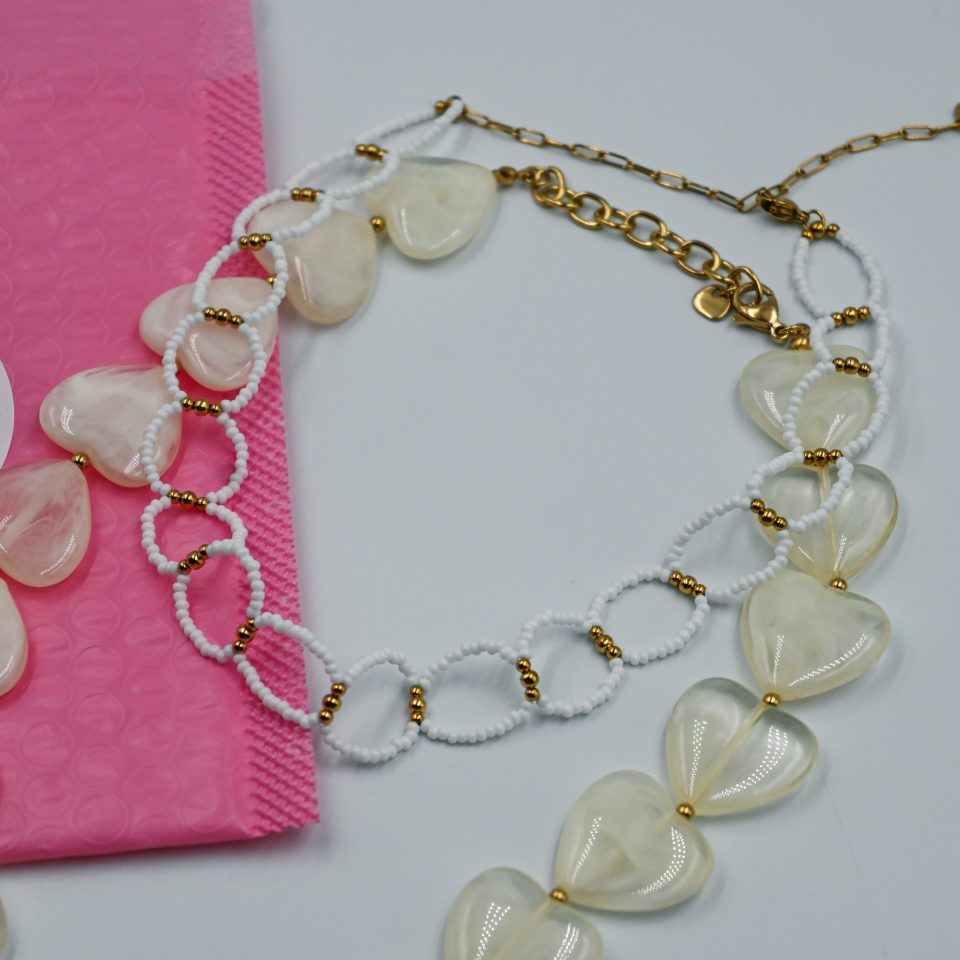 Solara beaded choker necklace with white beads and gold-tone steel details. A playful, saltwater-resistant summer essential for women and teen girls.