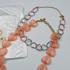 Colorful beaded choker necklace with vibrant colored beads and gold-tone steel details. A playful, saltwater-resistant summer essential for women and teen girls.