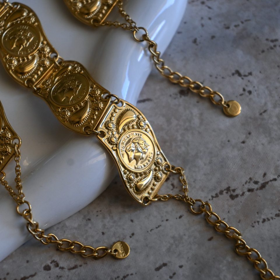 Helios coin statement bracelet with intricate design. Bold, iconic, and perfect for adding a unique and powerful touch to any look.