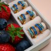 Aegean gold-plated steel earrings with blue zircon stones