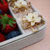 Elegant gold ring with white flower detail