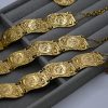 Helios coin statement bracelet with intricate design. Bold, iconic, and perfect for adding a unique and powerful touch to any look.