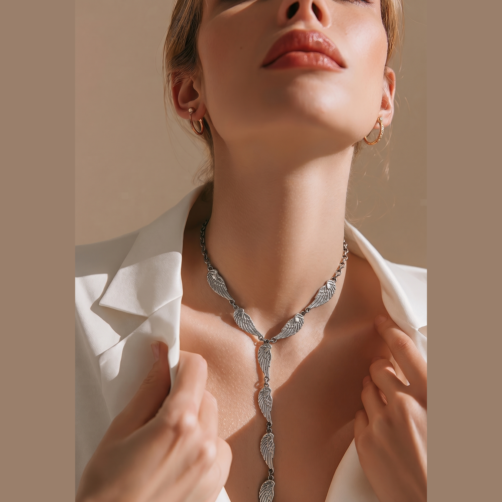 Stunning Angel Wings Silver Tie Necklace crafted from durable stainless steel with silver plating and engraved angel wing elements. Perfect for the summer months, it highlights the neckline and draws all eyes.