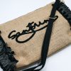 Black raffia beach clutch with detachable shoulder strap and spacious interior.