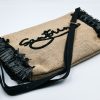 Black raffia clutch bag with embroidered Santorini detail and decorative tassels.