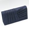 Kallisti Midnight Clutch Bag made of shimmering dark blue fabric with elegant front design, detachable silver chain, magnetic closure, dark blue lining, and interior pocket.