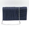 Kallisti Midnight Clutch Bag made of shimmering dark blue fabric with elegant front design, detachable silver chain, magnetic closure, dark blue lining, and interior pocket.